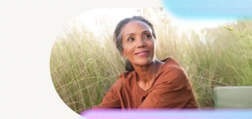 Image of woman sitting in a grass field symbolising sustainability for ESG